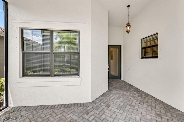 11643 Riverstone Ln, Fort Myers, FL 33913 - view of exterior entry with a patio and stucco siding