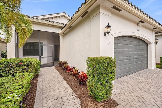 11643 Riverstone Ln, Fort Myers, FL 33913 - exterior space featuring a tiled roof, a garage, stucco siding, and decorative driveway