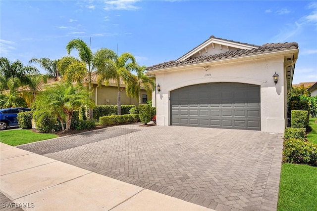 11643 Riverstone Ln, Fort Myers, FL 33913 - view of front of home with a garage, stucco siding, decorative driveway, and a tile roof