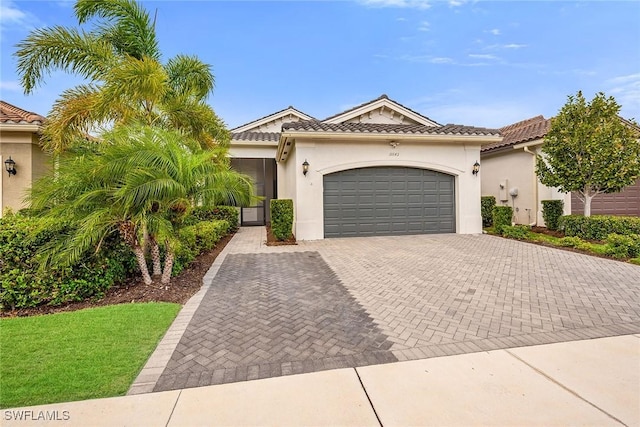 11643 Riverstone Ln, Fort Myers, FL 33913 - view of front facade featuring a garage, stucco siding, a tiled roof, and decorative driveway