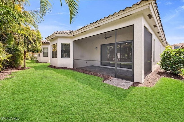 11643 Riverstone Ln, Fort Myers, FL 33913 - back of house featuring a yard, a tile roof, a sunroom, and stucco siding