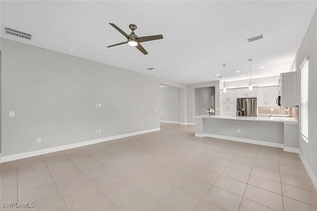 11643 Riverstone Ln, Fort Myers, FL 33913 - unfurnished living room with visible vents, baseboards, and ceiling fan