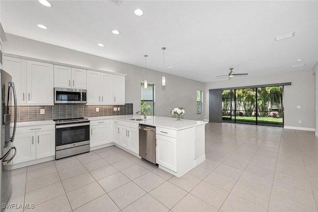 11643 Riverstone Ln, Fort Myers, FL 33913 - kitchen with appliances with stainless steel finishes, open floor plan, a peninsula, decorative backsplash, and a sink