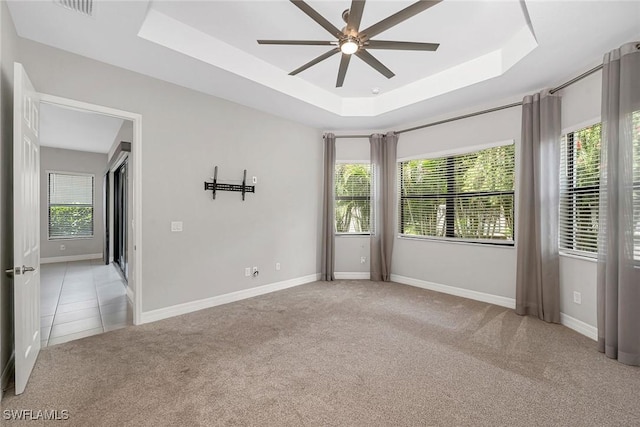11643 Riverstone Ln, Fort Myers, FL 33913 - unfurnished room with a tray ceiling, light carpet, a ceiling fan, and plenty of natural light