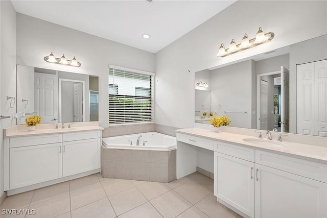 11643 Riverstone Ln, Fort Myers, FL 33913 - full bathroom featuring tile patterned flooring, a garden tub, a sink, and two vanities