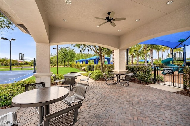 11643 Riverstone Ln, Fort Myers, FL 33913 - view of patio featuring outdoor dining space, fence, playground community, and ceiling fan