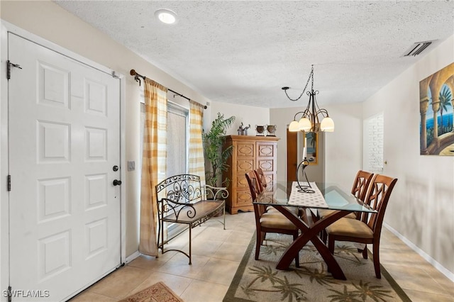 2209 SE 10th Ave, Cape Coral, FL 33990 - dining room with baseboards, an inviting chandelier, light tile patterned flooring, and a textured ceiling