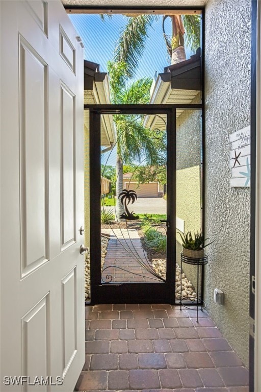12740 Seaside Key Ct, North Fort Myers, FL 33903 - doorway with tile patterned flooring and healthy amount of natural light