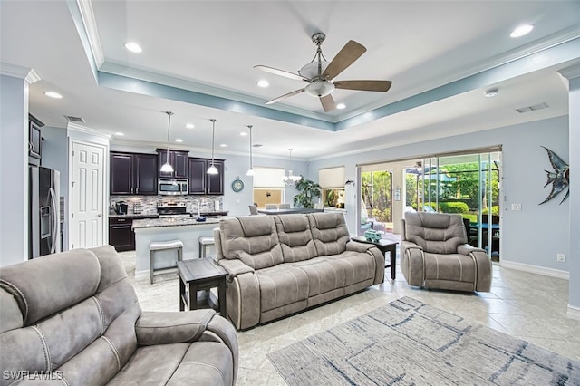 12740 Seaside Key Ct, North Fort Myers, FL 33903 - living room with ceiling fan, a tray ceiling, recessed lighting, and crown molding