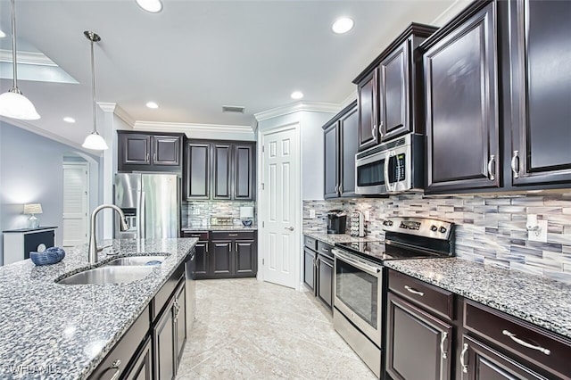 12740 Seaside Key Ct, North Fort Myers, FL 33903 - kitchen with appliances with stainless steel finishes, light stone countertops, pendant lighting, crown molding, and backsplash