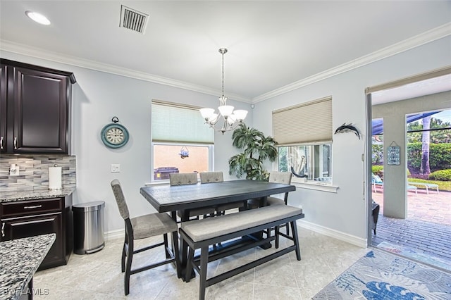 12740 Seaside Key Ct, North Fort Myers, FL 33903 - dining space with a chandelier and crown molding