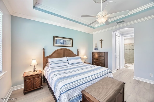 12740 Seaside Key Ct, North Fort Myers, FL 33903 - bedroom featuring arched walkways, light wood-style floors, ornamental molding, a tray ceiling, and a ceiling fan