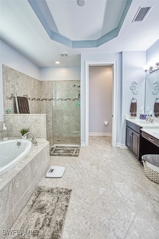 12740 Seaside Key Ct, North Fort Myers, FL 33903 - full bath with a garden tub, vanity, a tile shower, tile patterned floors, and a tray ceiling