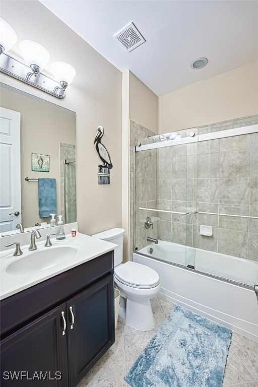 12740 Seaside Key Ct, North Fort Myers, FL 33903 - full bath featuring vanity, combined bath / shower with glass door, and tile patterned floors
