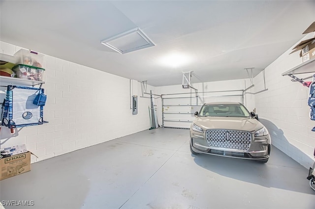 12740 Seaside Key Ct, North Fort Myers, FL 33903 - garage with a garage door opener, electric panel, and concrete block wall
