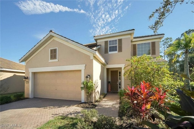 3268 Aralia Ct E, Alva, FL 33920 - traditional home with stucco siding, decorative driveway, and a garage