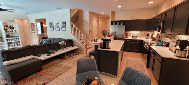 3268 Aralia Ct E, Alva, FL 33920 - kitchen with stainless steel appliances, open floor plan, light countertops, tasteful backsplash, and recessed lighting
