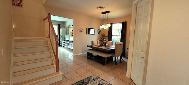 3268 Aralia Ct E, Alva, FL 33920 - dining room featuring stairway, light tile patterned flooring, and a chandelier