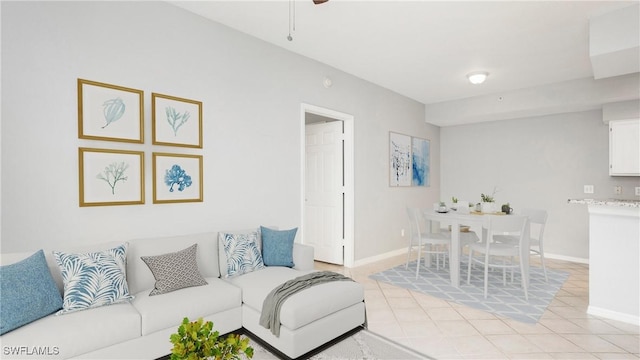living room featuring light tile patterned floors and baseboards