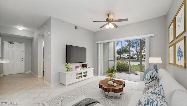 living room with baseboards, visible vents, a ceiling fan, and light tile patterned flooring