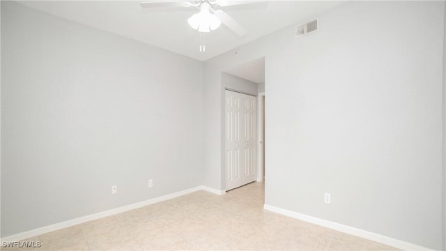 unfurnished room with baseboards, visible vents, and ceiling fan