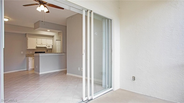 interior space featuring a ceiling fan