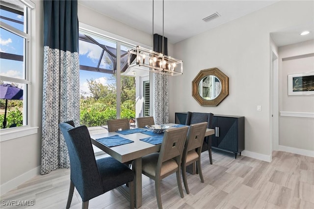641 Diplomat Ct, Marco Island, FL 34145 - dining space featuring visible vents, baseboards, light wood finished floors, and an inviting chandelier