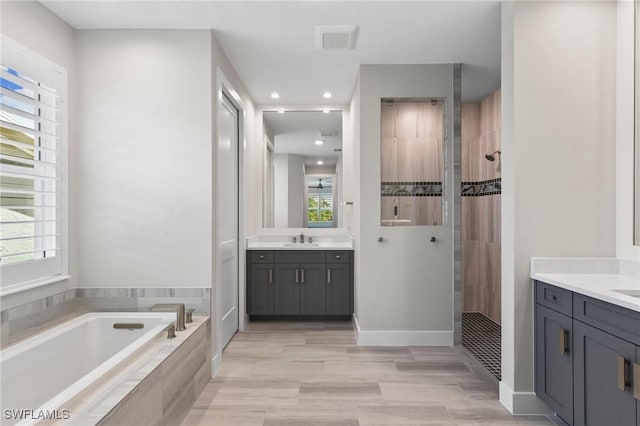 641 Diplomat Ct, Marco Island, FL 34145 - bathroom with tiled shower, two vanities, and a healthy amount of sunlight