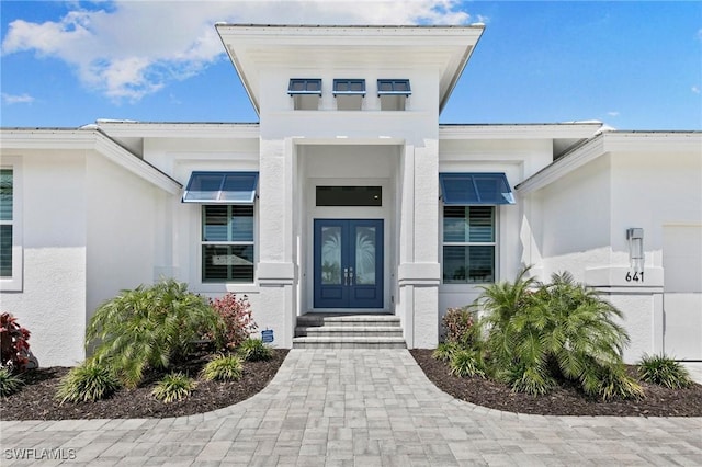 641 Diplomat Ct, Marco Island, FL 34145 - view of exterior entry featuring french doors and stucco siding