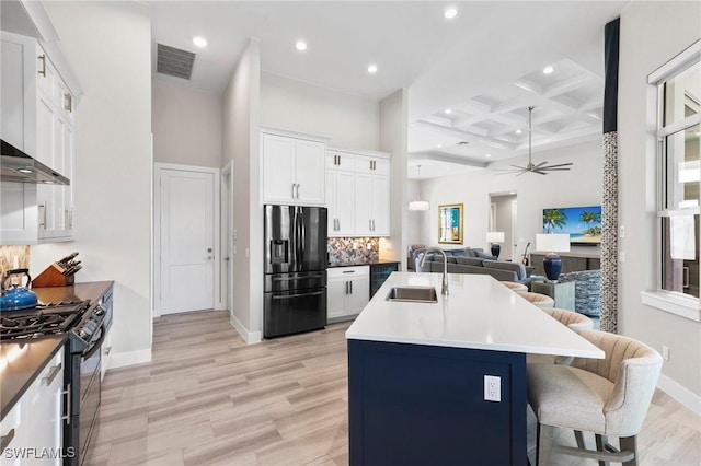 641 Diplomat Ct, Marco Island, FL 34145 - kitchen with refrigerator with ice dispenser, open floor plan, black gas range, coffered ceiling, and a sink