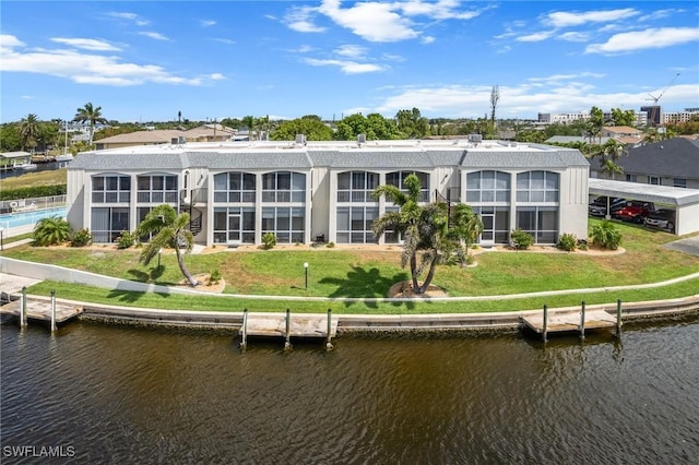 rear view of house featuring a water view