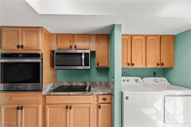 clothes washing area with independent washer and dryer and laundry area