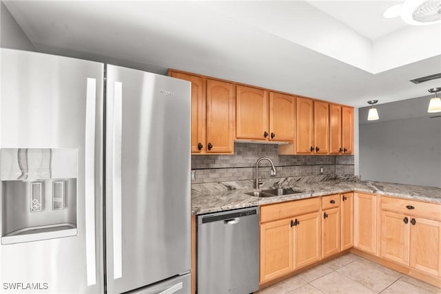 kitchen with light stone counters, a sink, light tile patterned flooring, tasteful backsplash, and appliances with stainless steel finishes