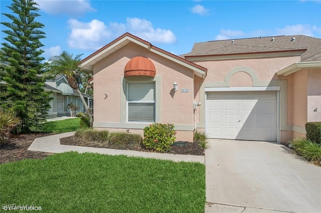20902 Blacksmith Frg, Estero, FL 33928 - view of front of home featuring driveway, a garage, stucco siding, and a front yard