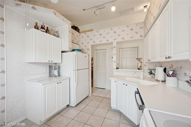20902 Blacksmith Frg, Estero, FL 33928 - kitchen featuring freestanding refrigerator, a sink, light tile patterned floors, light countertops, and white cabinetry
