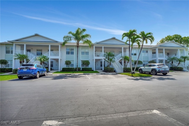 1180 Sarah Jean Cir Unit G202, Naples, FL 34110 - view of property featuring stairway and uncovered parking