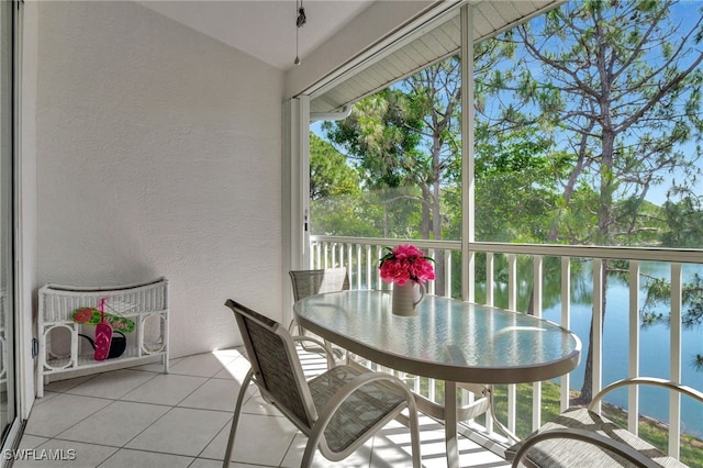 sunroom / solarium with a water view