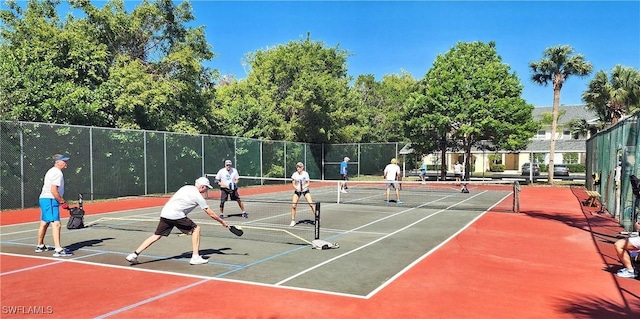 view of sport court featuring fence