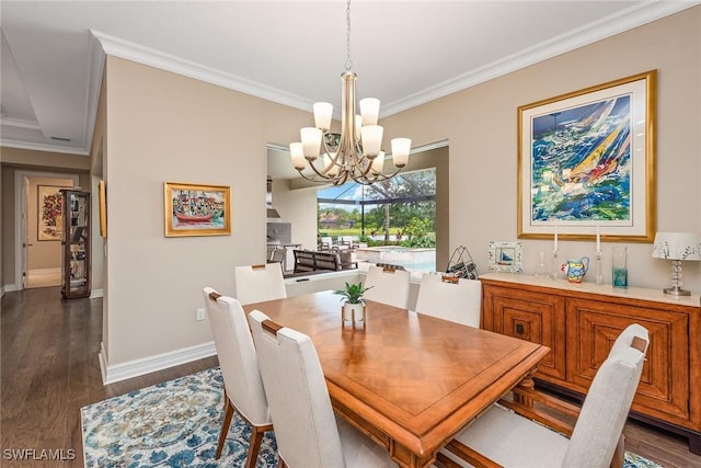 dining area with dark wood-type flooring, ornamental molding, baseboards, and a chandelier