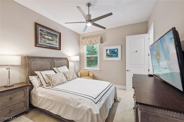 bedroom with light carpet, baseboards, and a ceiling fan