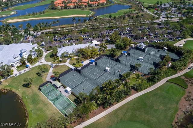 drone / aerial view with a residential view, view of golf course, and a water view