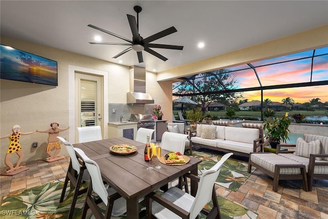 exterior space with stone finish floor, a textured wall, ceiling fan, and recessed lighting