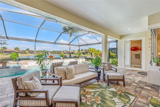 view of patio with a water view, outdoor lounge area, an in ground hot tub, and a lanai