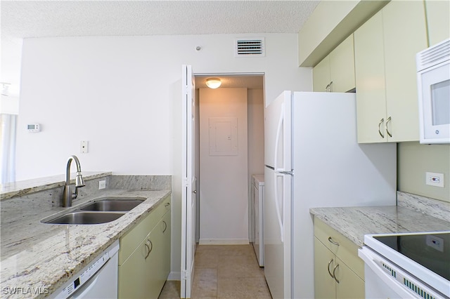 kitchen with white appliances, light tile patterned floors, a textured ceiling, visible vents, and a sink