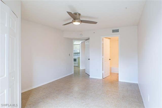 empty room featuring ceiling fan, baseboards, and visible vents