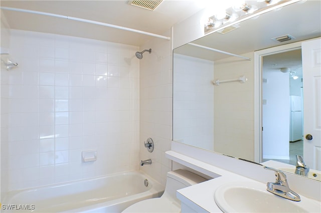 full bathroom featuring toilet, vanity, washtub / shower combination, and visible vents