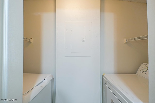 washroom featuring laundry area, washing machine and clothes dryer, and electric panel