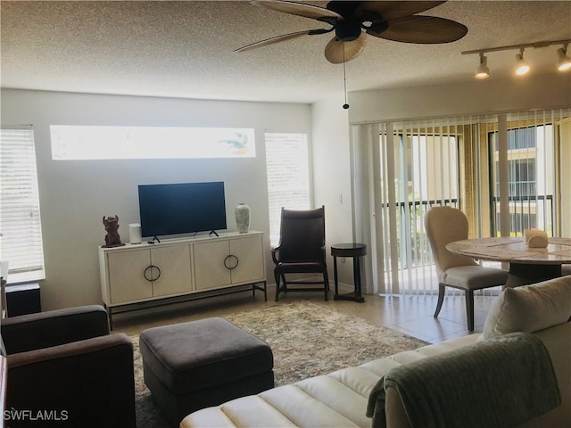 living room featuring a textured ceiling, ceiling fan, tile patterned flooring, and rail lighting