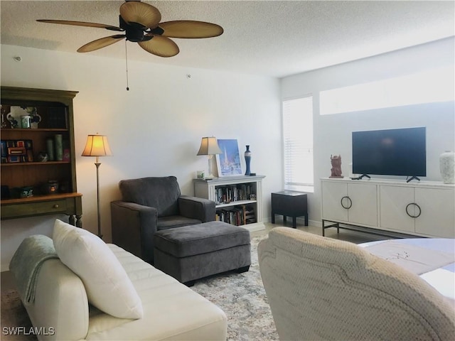 living room with a textured ceiling and a ceiling fan