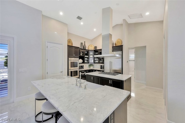 27080 Flamingo Dr, Bonita Springs, FL 34135 - kitchen featuring a breakfast bar area, a large island, visible vents, baseboards, and stainless steel appliances